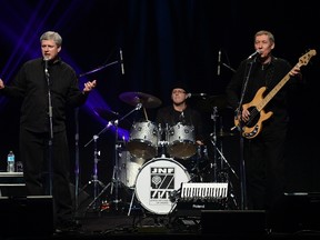 Prime Minister Stephen Harper (left) and Phillip Nolan, who is facing a number of historical sex charges (centre) plays with his band Herringbone at the Negev Dinner 2013, organized by the Jewish National Fund of Toronto, in Toronto December 1, 2013. REUTERS/Aaron Harris