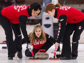 Team Canada skip Jennifer Jones (centre) and second Jill Officer (left) are long-time friends and will share their dream of competing at the Olympics. (ERROL McGIHON/QMI Agency)