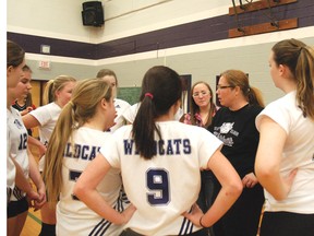 Lori Smith, coach of the junior girls volleyball team, reviews strategy with her team at Thursday's quarterfinal playoff matches against Lord Dorchester Secondary School. West Elgin won the matches.