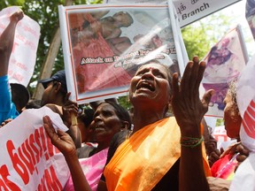 A mother from the "Dead and Missing Person's Parents Front" organization cries as she shouts slogans during a protest against U.N. High Commissioner for Human Rights Navi Pillay's visit in front of the U.N. headquarters in the Sri Lankan capital Colombo in August 2013. 
REUTERS/QMI Agency