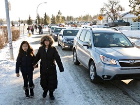 Traffic is backed up next to Westbrook School during an Edmonton Police Service press event about congested traffic flow in school zones at Westbrook School on Thursday. Police said that chronic traffic congestion in school zones is creating danger for kids. (CODIE MCLACHLAN/EDMONTON SUN)