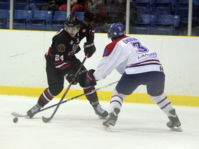 Sarnia Legionnaires forward Riley Roberts (in black) tries to get by Strathroy Rockets defenceman Jordan DaSilva in the first period of their game in Sarnia on Thursday, Feb. 6. Roberts scored the Legionnaires third of five goals in a 5-0 win over the Rockets. SHAUN BISSON/THE OBSERVER/ QMI AGENCY