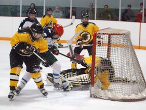 Parkside forward Kennedie Fife (foreground, second from left) crashes the net while Central Elgin player Christine Black (left) and goaltender Hunter Smith try to keep her from scoring. There was no goal on the play but Parkside was able to bury other rebounds in a 5-1 win Thursday at the Timken Centre in St. Thomas. Ben Forrest/Times-Journal