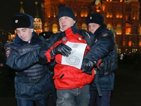 Interior Ministry members detain an unidentified activist during a protest rally near the Kremlin in central Moscow, February 6, 2014. (REUTERS)