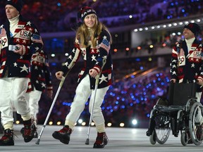 US skier Heidi Kloser walks with crutches as she parades with her delegation during the Opening Ceremony of the Sochi Winter Olympics at the Fisht Olympic Stadium on February 7, 2014 in Sochi. (AFP PHOTO)