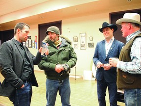 John Barlow, running for the Macleod Riding Conservative seat, talks with Nanton Town Coun. Christophe Labrune, country music artist and actor George Canyon and former Nanton mayor John Blake at an open house in Nanton Jan. 29. Sheena Read QMI Agency