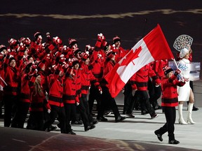 Team Canada women's hockey player and opening ceremony flag-bearer Hayley Wickenheiser leads the Canadian athletes into Fisht Olympic Stadium to start the Sochi 2014 Winter Olympics  in Sochi, Russia, Feb. 7, 2014. (AL CHAREST/QMI Agency)