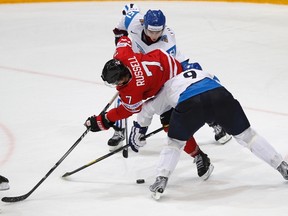 Canada's Kris Russel scuffles with Finland's Valtteri Filppula and Mikko Koivu (L-R) during their 2012 world championship game (Grigory Dukor/Reuters)