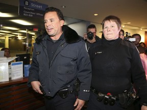 Two Toronto Police officers leave City Hall Friday after visiting Mayor Rob Ford's office. (Veronica Henri/Toronto Sun)
