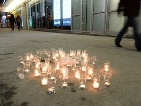 Candles sit where Alain Magloire, a homeless person, was shot in the street by the Montreal police February 4, 2014. (MAXIME DELAND/QMI AGENCY)