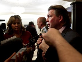 Jobs, Skills, Training and Labour minister Thomas Lukaszuk speaks with reporters after the swearing in of Premier Alison Redford's new cabinet at Government House in Edmonton, Alta., Dec. 13, 2013. (Ian Kucerak/Edmonton Sun/QMI Agency)