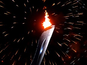 Fireworks explode over the Olympic Flame outside the Fisht Olympic Stadium during the opening ceremonies of the Sochi 2014 Winter Olympics on Feb. 7, 2014. 
(AL CHAREST/QMI Agency)