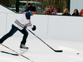 Spruce Grove’s Nathan Dempsey (left), a member of the NHL alumni team that took part in the Clymont Hockey Day on Feb. 1 joins in on the rush with ex-Edmonton Oilers captain Al Hamilton during the pick-up hockey game that also starred several area residents. The special game, played on the Rink of Dreams, was staged as a fundraising idea for Threads of Life, an organization dedicated to helping those affected by workplace illness, accidents or death. - Gord Montgomery, Reporter/Examiner