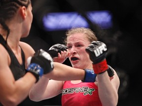 Sarah Kaufman (red gloves) fights against Jessica Eye (blue gloves) in their women's bantamweight bout during UFC 166 at Toyota Center on Oct 19, 2013 in Houston, TX, USA. (Andrew Richardson/USA TODAY Sports)