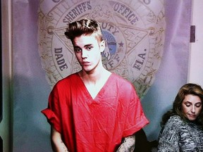 Pop singer Justin Bieber appears via video conference in his first court appearance after being arrested on a drunk driving charge in Miami, Florida in this file photo taken January 23, 2014.  Bieber, who racked up charges in two cities in the span of a week, would be wise to use provocative songstress Miley Cyrus as his guide to navigate the transition from teen pop stardom to a serious adult career, branding and celebrity crisis experts said.  REUTERS/Walter Michot/Files