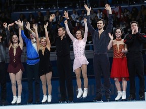 The Canadian figure skating team celebrate on the podium at the Sochi 2014 Winter Olympics, Feb. 9. From L-R: Patrick Chan, Kaetlyn Osmond, Kevin Reynolds, Kirsten Moore-Towers and Dylan Moscovitch, Meagan Duhamel and Eric Radford, Tessa Virtue and Scott Moir. 
REUTERS/Alexander Demianchuk