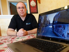 Paul Labelle is photographed in his home in Ottawa Sunday Feb. 9, 2014 with his laptop showing a dash-cam video he recorded in which he alleges a STO bus driver "played chicken" with him on Wellington St. Saturday. 
Darren Brown/Ottawa Sun/QMI Agency