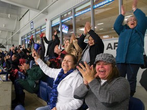 Hockey parents and friends cheer a goal at the Western Fair Sports Centre in London. Hockey parents in the OMHA who have a child registered for the 2014 season will be required to take an online course called Respect in Hockey. (MIKE HENSEN, The London Free Press)