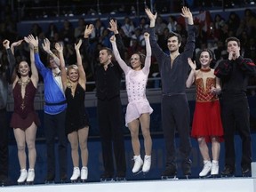The Canadian figure skating team celebrate on the podium at the Sochi 2014 Winter Olympics, February 9, 2014. From L-R: Patrick Chan, Kaetlyn Osmond, Kevin Reynolds, Kirsten Moore-Towers and Dylan Moscovitch, Meagan Duhamel and Eric Radford, Tessa Virtue and Scott Moir.  REUTERS/Alexander Demianchuk (RUSSIA  - Tags: SPORT FIGURE SKATING OLYMPICS)