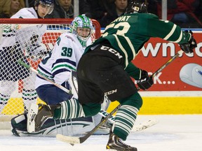 Bo Horvat tries to deflect a puck past Plymouth goalie Alex Nedeljkovic during their OHL game at Budweiser Gardens on Sunday. The Knights won 5-4. (MIKE HENSEN, The London Free Press)