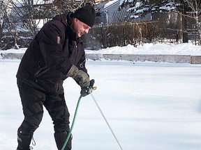 Belleville native Kevin McDermott, of Kingston, demonstrates his Manzoni backyard rink ice resurfacing tool. (IAN MacALPINE/Kingston Whig Standard)