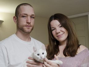 Jason Coleman and Amber LaPointe with their kitten, Lily. The couple is still trying to find a new home after being displaced by the midtown fire in December. (Julia McKay The Whig-Standard)