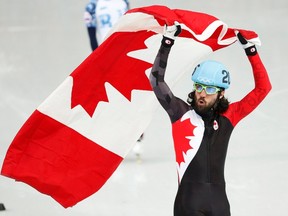 Canada's Charles Hamelin celebrates winning the men's 1,500-metre short-track speed skating final at the Iceberg Skating Palace during the 2014 Sochi Winter Olympics February 10, 2014. (REUTERS)