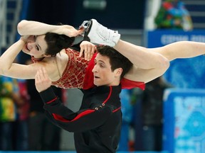 Tessa Virtue and Scott Moir of Canada's figure skating team compete during the team ice dance free dance at the Sochi 2014 Winter Olympics, Feb. 9, 2014. (LUCY NICHOLSON/Reuters)