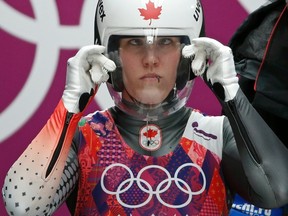 Canada's Alex Gough adjusts her helmet at the start of a run in the women's singles luge event at the Sanki Sliding Center for the 2014 Sochi Winter Olympics, Feb. 10, 2014. (MURAD SEZER/Reuters)