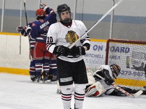 Brent Rae (10) of the Mitchell Hawks looks on in dismay while members of the Kincardine Bulldogs celebrate a first period goal during action from Game 3 of their Western Jr. C quarter-final series Saturday. The Hawks rallied from a 4-1 third period deficit only to lose 5-4 in overtime, and trail the best-of-seven series 3-1. ANDY BADER/MITCHELL ADVOCATE