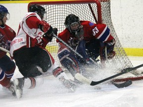 Strathroy Rockets goalie Tynan Lauziere watches as Leamington’s J.P. Grineau crashes the net during GOJHL action at the West Middlesex Memorial Centre Feb. 9. Lauziere made 27 saves in a 2-1 victory.
JACOB ROBINSON/AGE DISPATCH/QMI AGENCY