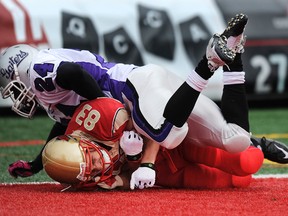 Julian Feoli Gudino of the Laval Rouge et Or gets tackled in the end zone by  Steven Adu, then of the Bishop's Gaiters on Nov. 6, 2010. The Ottawa RedBlacks announced Monday they had signed Adu to a contract. (DIDIER DEBUSSCHERE/JOURNAL DE QUEBEC/AGENCE QMI)