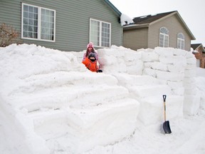 Olivia and Carson Gosling play in the snow fort that sits on the front lawn of their Albert St., Mitchell home. They built the snow fort with their dad Graham this January after record amounts of snow blanketed the area in recent weeks. SUBMITTED PHOTO