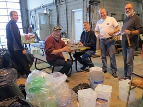 Mitchell Rotarians Mike Kraemer (left), Peter Huitema, Scott Wilson, Paul Van Gerwen and John Hohner prepare some lanterns which will be in use during the 4th annual Lantern Walk In The Woodlands next Sunday, Feb. 16. GERRY KEHL PHOTO