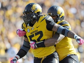 Missouri Tigers defensive lineman Michael Sam (52) is congratulated by defensive lineman Lucas Vincent (96) after sacking Florida Gators quarterback Tyler Murphy  at Faurot Field in Columbia, Missouri in this file photo from October 19, 2013. (Denny Medley/USA TODAY Sports)