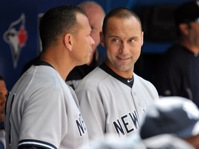New York Yankees infielders Alex Rodriguez (left) and Derek Jeter stand in the dugout during their American League game against the Toronto Blue Jays in Toronto in this file photo from September 29, 2012. (REUTERS/Mike Cassese/Files)
