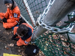 Two Greenpeace activists chain themselves to the front gate of Kinder Morgan oil pumping facility in Burnaby, B.C. on Wednesday October 16, 2013. (Carmine Marinelli/QMI Agency)