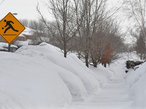 Snowbanks across the city are reaching two metres in height and higher as snow continues to accumulate.
IAN MCINROY/BARRIE EXAMINER/QMI AGENCY