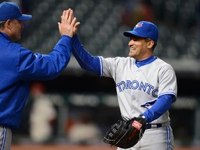 Former Blue Jays manager John Farrell (left) and Omar Vizquel did not see eye-to-eye during the 2012 season. (Getty Images)