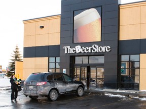 A customer exits The Beer Store in Ottawa on Monday February 10, 2014. (Errol McGihon/QMI Agency)