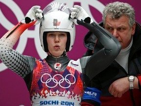 Canada's Alex Gough adjusts her helmet as her coach looks on at the start of a run in the women's singles luge event at the 2014 Sochi Winter Olympics, at the Sanki Sliding Center in Rosa Khutor February 10, 2014. (REUTERS)
