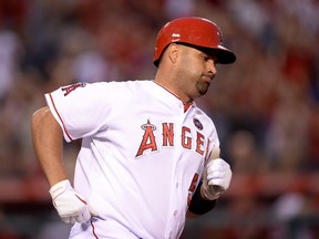 Albert Pujols of the Los Angeles Angels hits a solo homerun at Angel Stadium of Anaheim on July 19, 2013. (Harry How/Getty Images/AFP)