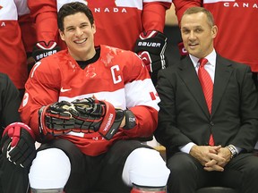 Team Canada's Sidney Crosby shares a laugh with head coach Mike Babcock  (L) and general manager Steve Yzerman during the team picture session at the 2014 Olympic Winter Games in Sochi, Russia, on Tuesday February 11, 2014. (Al Charest/QMI Agency)