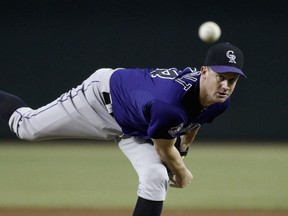 Roy Oswalt of the Colorado Rockies delivers a pitch against the Arizona Diamondbacks during MLB play at Chase Field on September 14, 2013 in Phoenix, Arizona. (Ralph Freso/Getty Images/AFP)