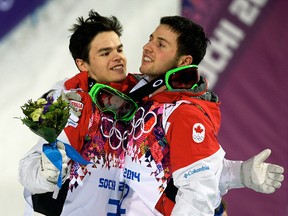 Canada's Alex Bilodeau (right) and Mikael Kingsbury celebrate their win of gold and silver medals, respectively, in men's moguls at the Rosa Khutor Extreme Center, Feb. 10, 2014 (DIDIER DEBUSSCHERE/QMI Agency)