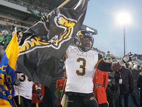 Marc Beswick, of the Hamilton Tiger-Cats, runs onto the field before the 101st CFL Grey Cup in Regina, Sask., on Sunday November 24, 2013. (Lyle Aspinall/QMI Agency)