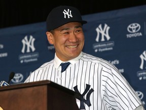 New York Yankees pitcher Masahiro Tanaka smiles during a press conference at Yankees Stadium Tuesday, February 11, 2014. (Noah K. Murray/USA TODAY Sports)