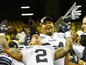 Toronto Argonauts Chad Owens (C) and Andrew Jones celebrate after their team defeated the Montreal Alouettes during the CFL's Eastern Conference Final football game in Montreal, November 18, 2012.    REUTERS/Olivier Jean