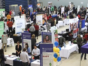 Queen's University and St. Lawrence College students check out the booths at a job fair in the Queen's University athletics centre Tuesday, Feb. 11,  in Kingston. 
MICHAEL LEA\THE WHIG STANDARD\QMI AGENCY
