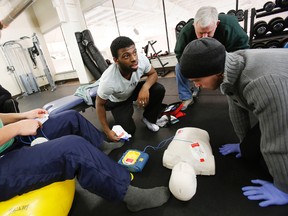 In recognition of February being Heart and Stroke month, Belleville Bulls defenceman Jordan Subban, centre, goaltender Charlie Graham, right, and left winger Stephen Harper learn how to use an automated external defibrillator (AED) and how to provide CPR during a one-hour workshop held by St. John Ambulance in the OHL team's gym at Yardmen Arena in Belleville, Ont. Tuesday, Feb. 11, 2014.  - JEROME LESSARD/The Intelligencer